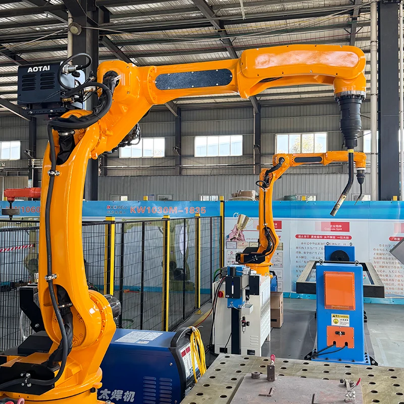 Close view of a yellow industrial robot in the workshop
